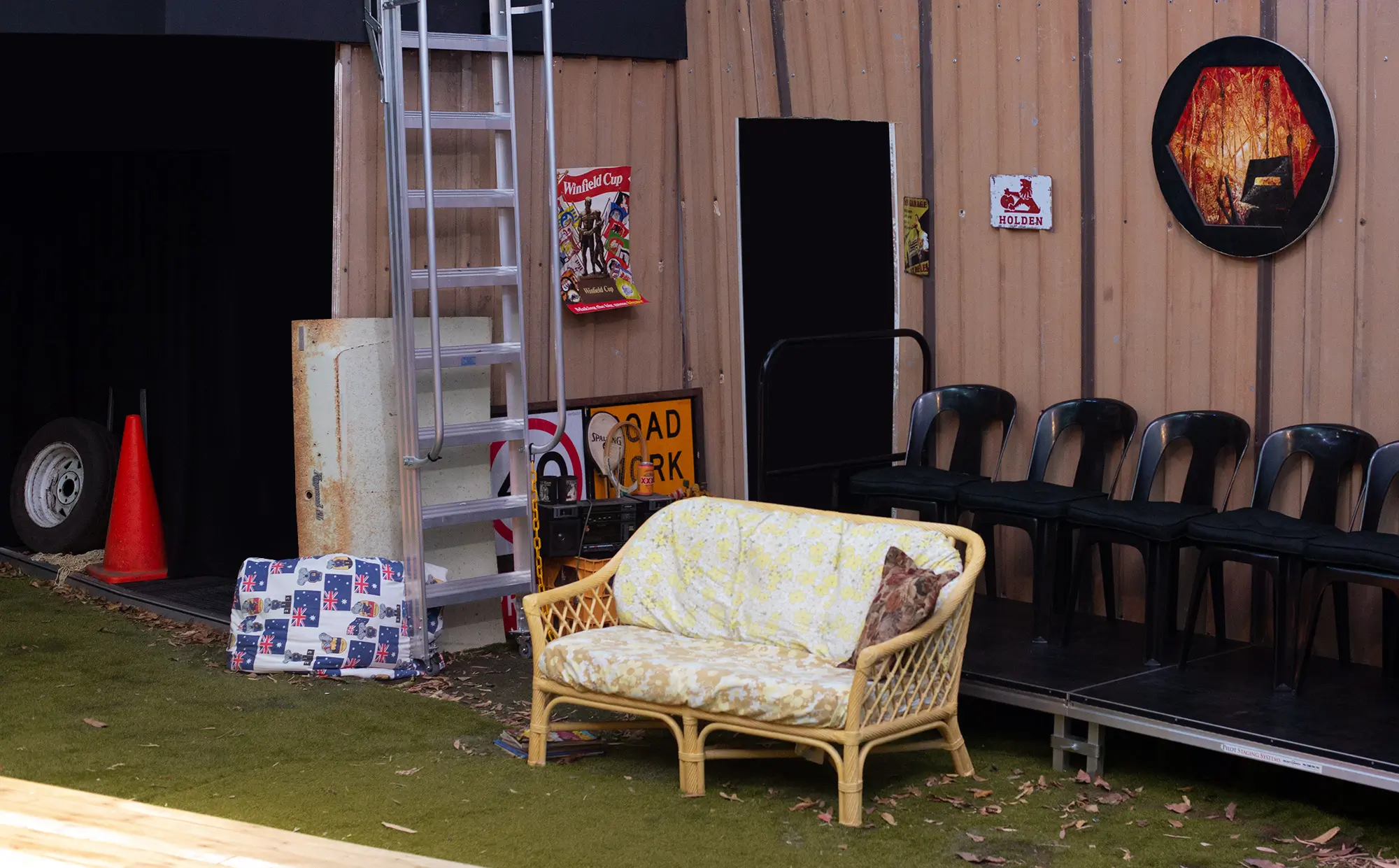 A theatre set: a Queensland car port containing very Queensland things